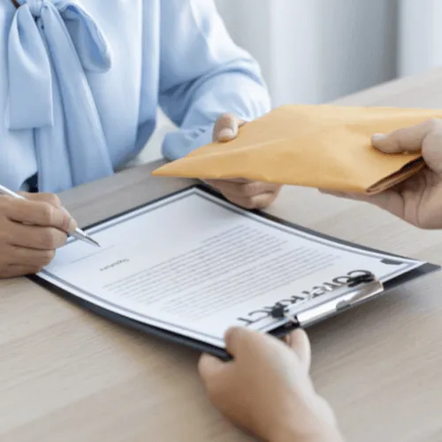 house seller getting cash for their property and signing closing documents